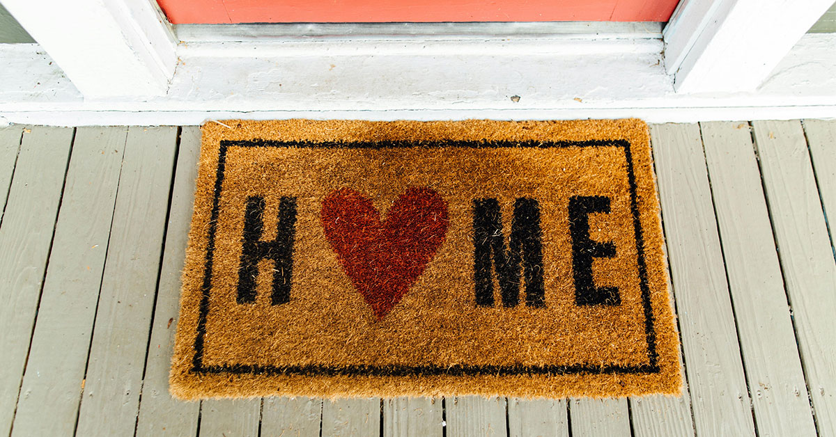 welcome home mat with a heart.